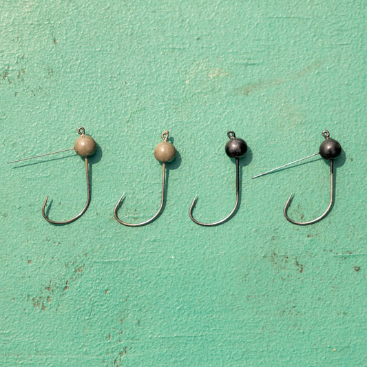 Reaction Tackle tungsten wacky jig heads 5-pack tan and black beadheads on hooks on teal background on Tampa Home & Garden Store
