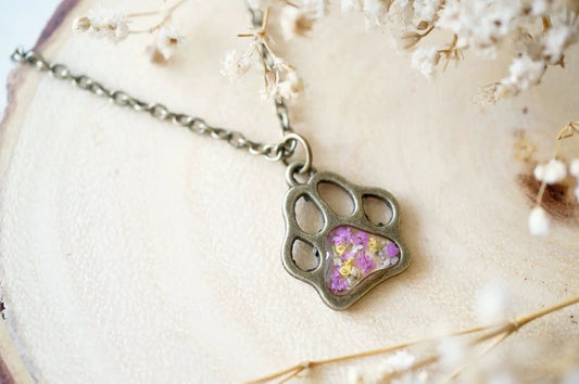 Necklace with real dried flowers encased in resin inside a silver dog paw pendant on a silver chain on Tampa Home & Garden Store