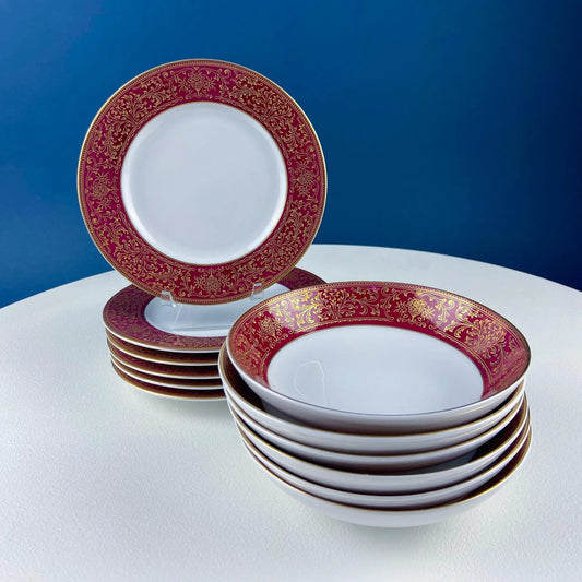 Porcelain red and gold floral salad plates with matching berry bowls, stacked in a decorative set on Tampa Home & Garden Store