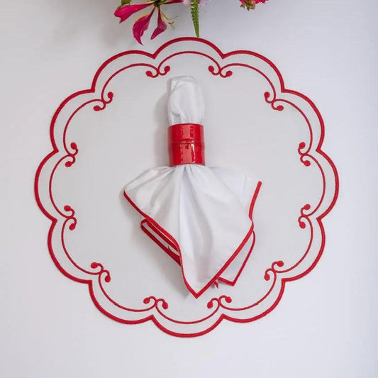 Royal placemat white napkin with red trim folded as bow on a red ornate circular display on Tampa Home & Garden Store