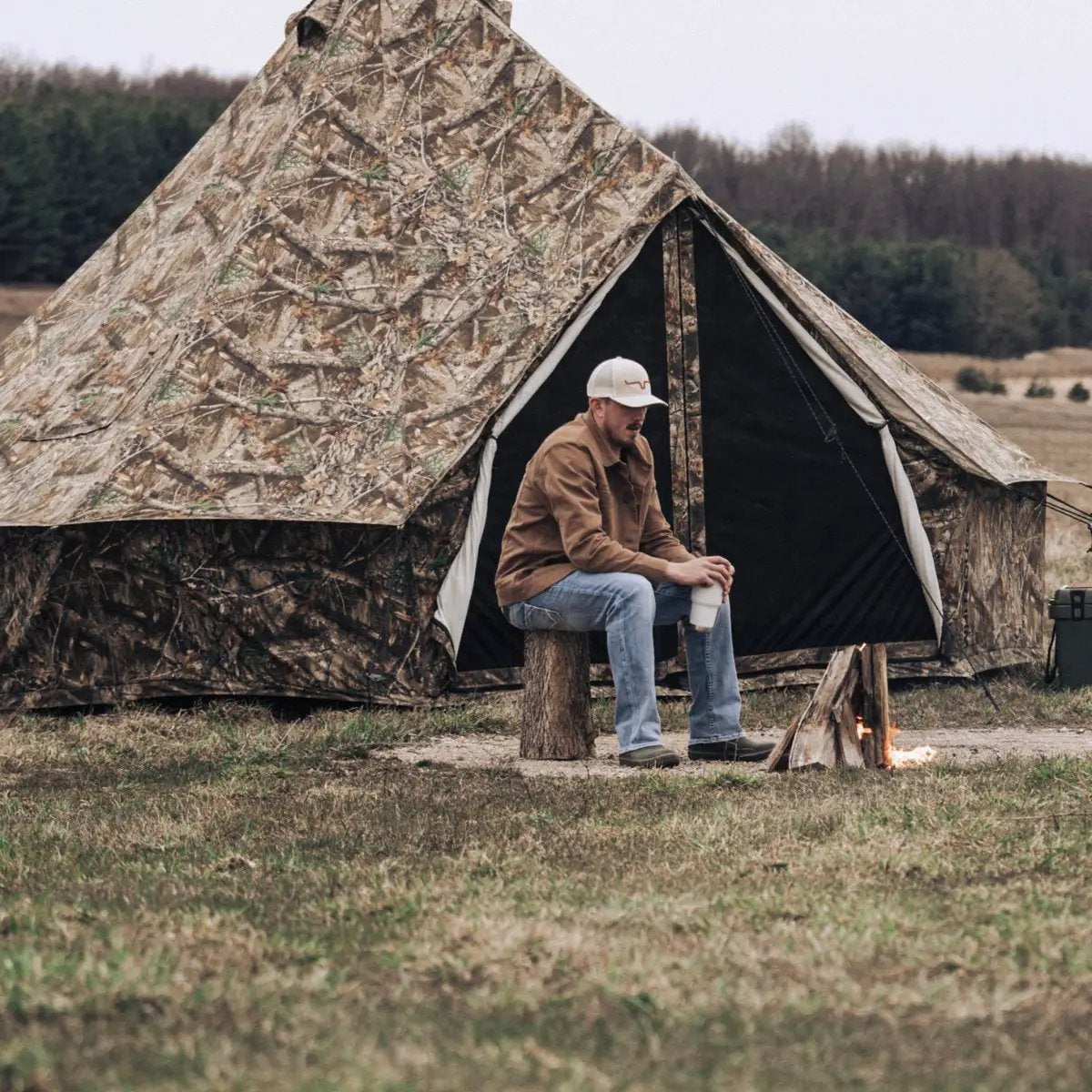 Regatta Bell Tent 10 ft camo camping tent with open doorway and seated man by campfire on Tampa Home & Garden Store