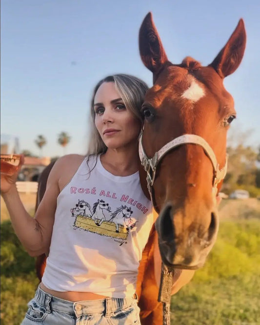 White T-shirt with Rosé All Neigh graphic of three horses in trough, beside a horse outdoors on Tampa Home & Garden Store