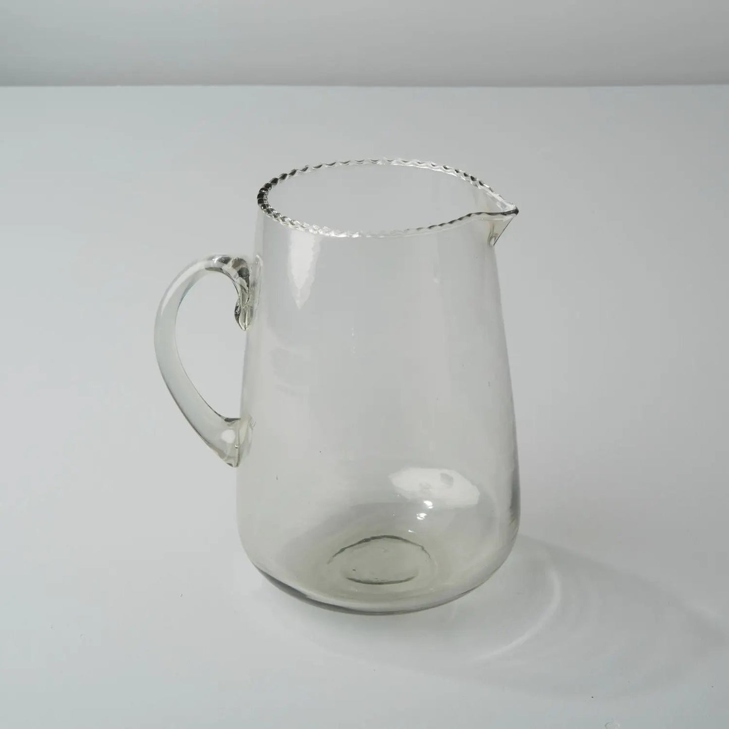 Elegant hand blown ruffle glass pitcher with a scalloped rim by White Cliff Studio on Tampa Home & Garden Store