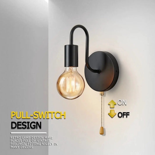 Moktan Sabai black wall sconce with curved arm and round backplate, Edison bulb on Tampa Home & Garden Store