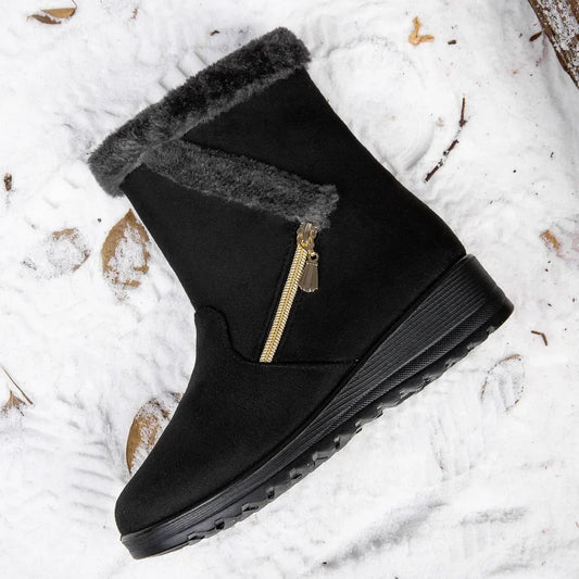 Women's black suede boot, ankle-height with faux fur trim and gold zipper, outsole on Tampa Home & Garden Store