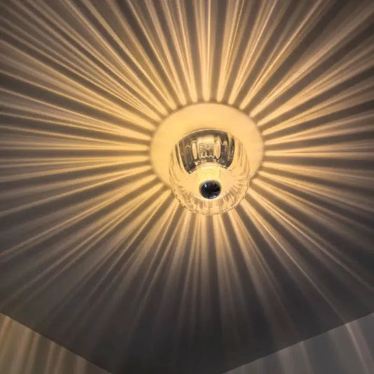 Nordic Bauhaus Glass Ceiling Light and Wall Lamp clear glass bulb with warm starburst glow on Tampa Home & Garden Store