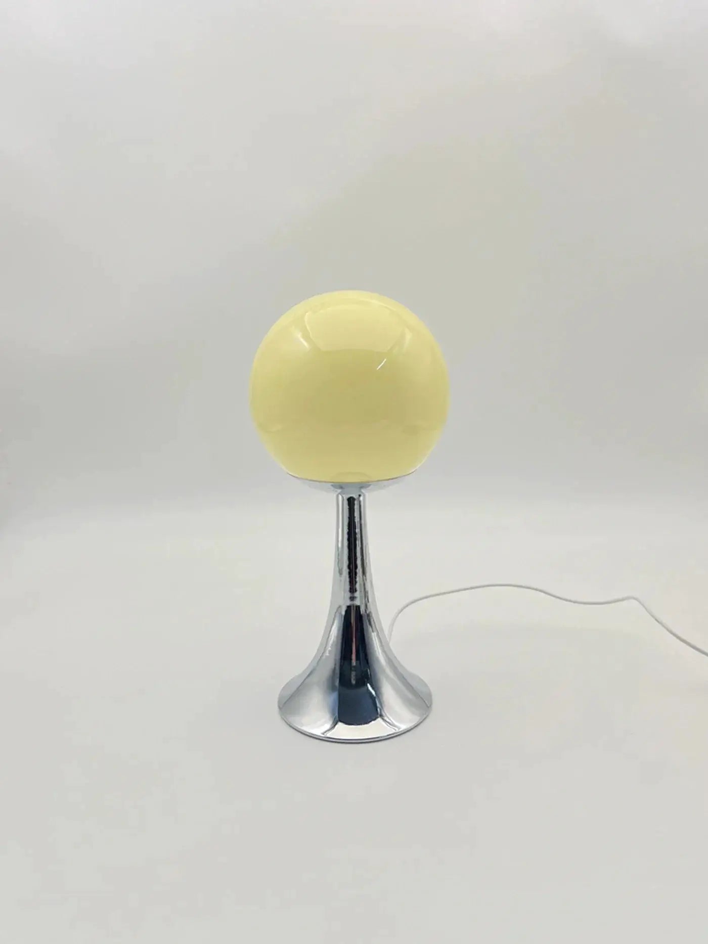 Custom glass round table lamp with yellow globe on chrome pedestal on Tampa Home & Garden Store