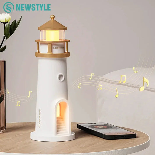 Moon projection night light in white lighthouse with gold cap glow on Tampa Home & Garden Store