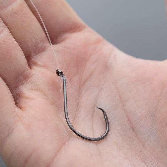 Reaction Tackle heavyweight catfish circle hook close-up in silver steel with line on Tampa Home & Garden Store