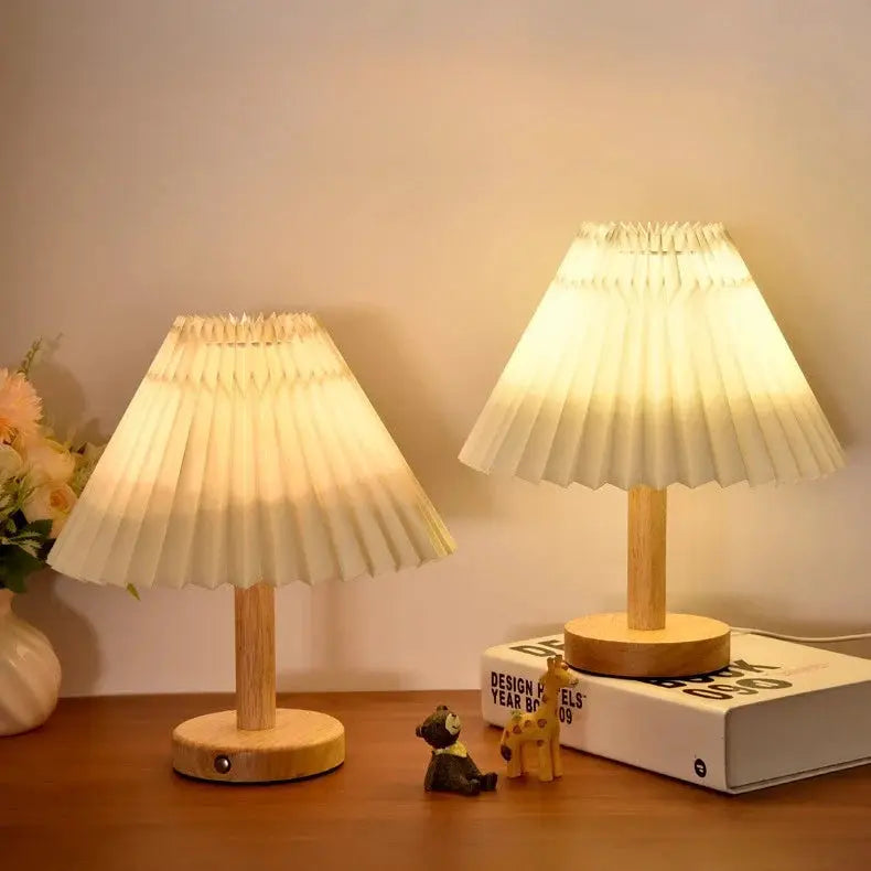 Two Moktan Sabai Nordic pleated LED USB foldable table lamps on a wooden table on Tampa Home & Garden Store