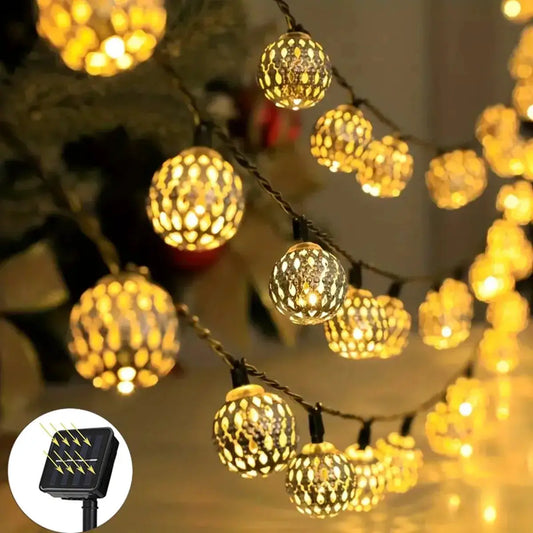 Moroccan Ball Solar String Lights with warm amber perforated globe lanterns on braided cord on Tampa Home & Garden Store