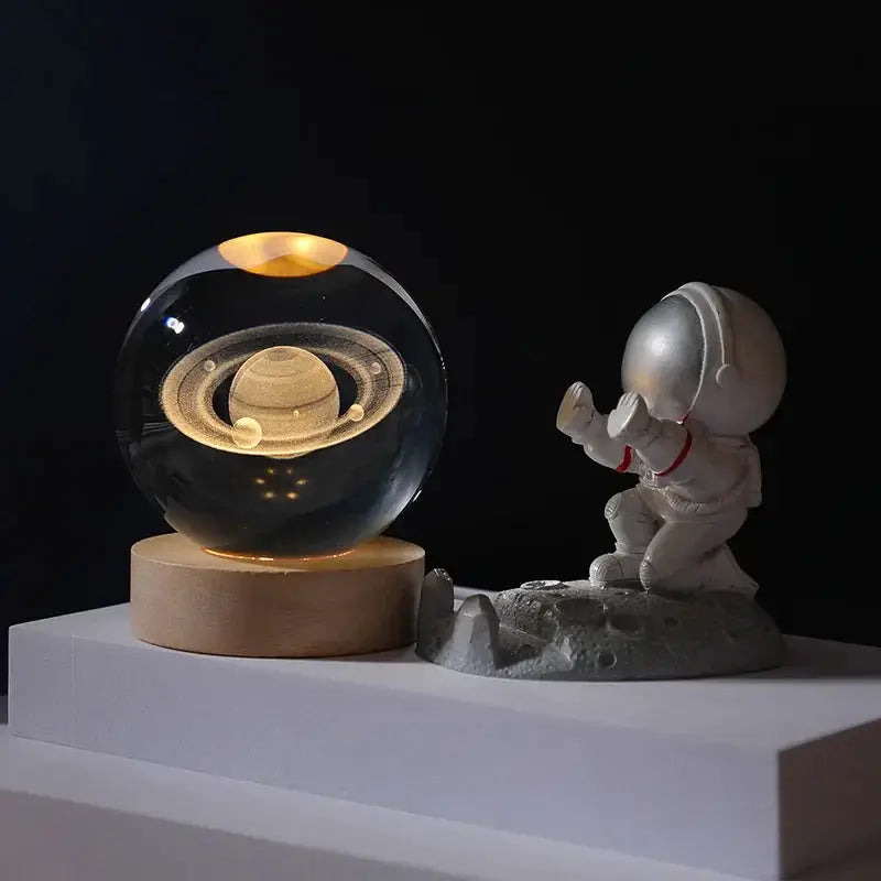 3D Galaxy Crystal Ball Night Light glass globe featuring Saturn inside on a wooden base on Tampa Home & Garden Store