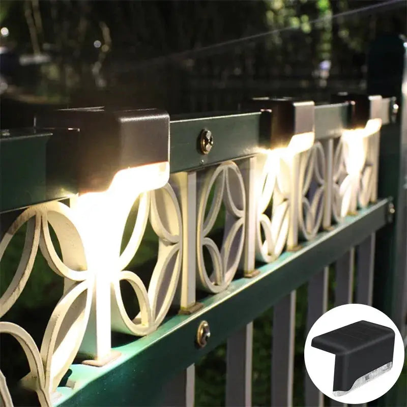 Multiple solar deck lights line green railing with warm white LEDs and lattice panels on Tampa Home & Garden Store