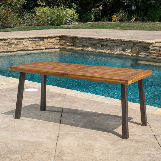 Acacia wood outdoor dining table with teak finish and dark metal legs by HomePacific poolside patio on Tampa Home & Garden Store
