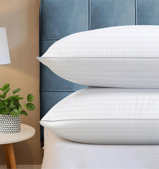 Set of 2 white queen down-alternative pillows with crisp covers on a bed with white linens on Tampa Home & Garden Store