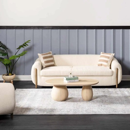Speaks Traditional Textured Luxe Rug in light neutral tones beneath sofa and blue wall on Tampa Home & Garden Store