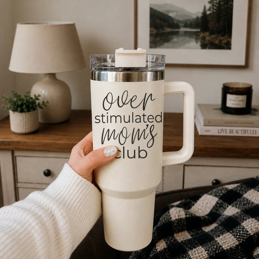 Over Stimulated 40oz insulated travel mug with cream body and mom's club script text on Tampa Home & Garden Store
