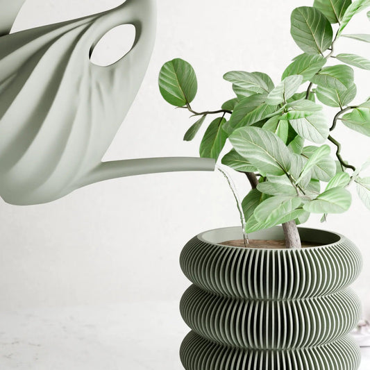 Swirl Watering Can Sculptural Spout Design in gray beside a plant in a ribbed planter on Tampa Home & Garden Store