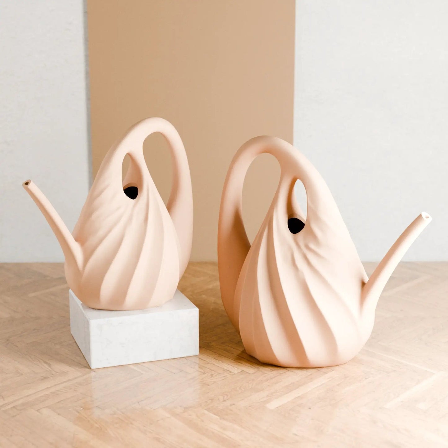 Swirl Watering Can sculpture trio by Modernized Pottery blush pink looping spouts on marble blocks on Tampa Home & Garden Store