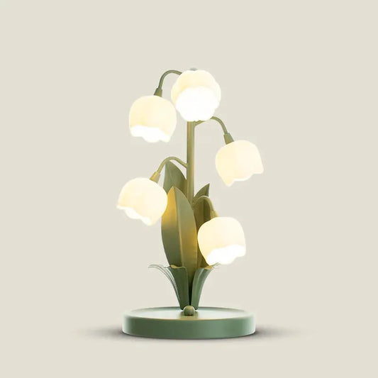 Vintage floral table lamp with lily-shaped white blossoms on a green stem base on Tampa Home & Garden Store