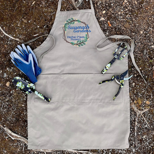 Sassenach Gardens Herbal Plant Nursery Apron in grey canvas with blue embroidery on Tampa Home & Garden Store
