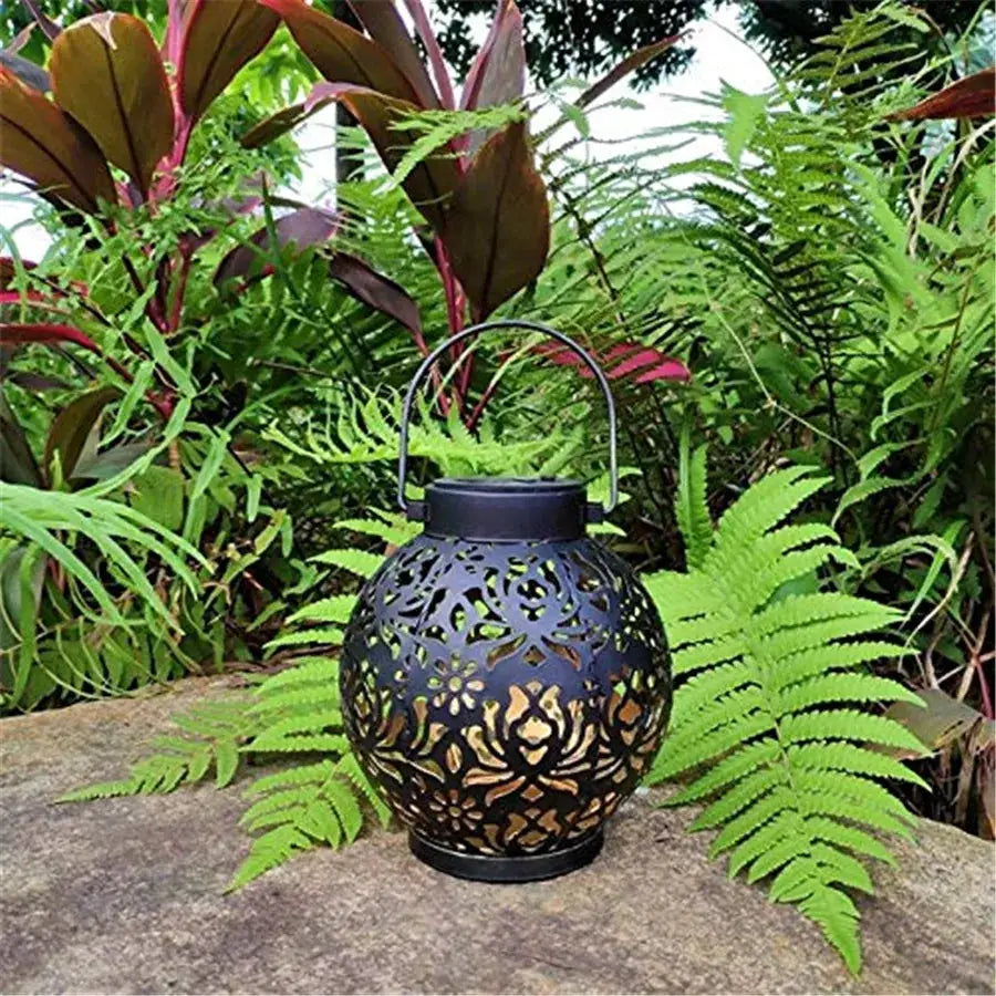 Outdoor solar garden hanging iron LED lantern with intricate floral cutouts in black metal on Tampa Home & Garden Store