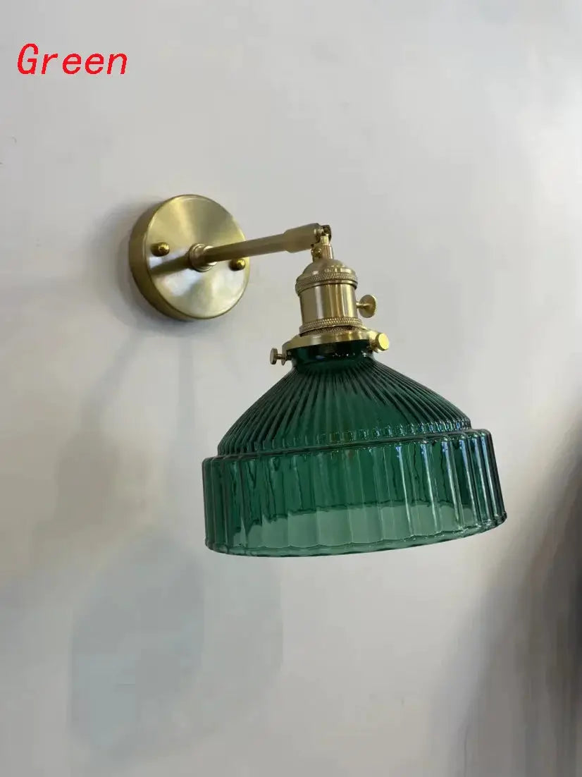 Green glass wall sconce with ribbed shade and brass mounting arm on Tampa Home & Garden Store