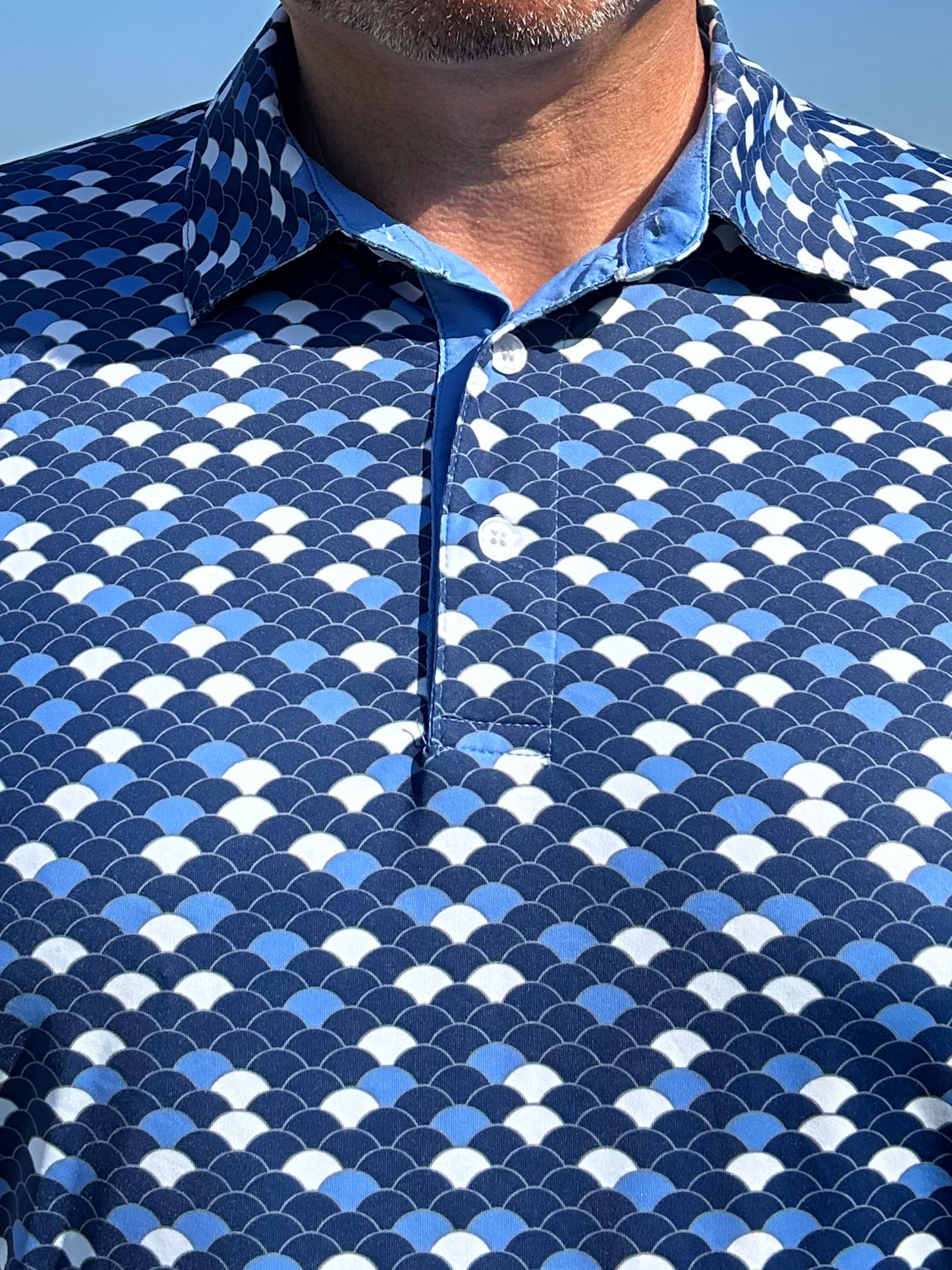 Scales Polo shirt in blue scale-pattern print with White Water Life branding on Tampa Home & Garden Store