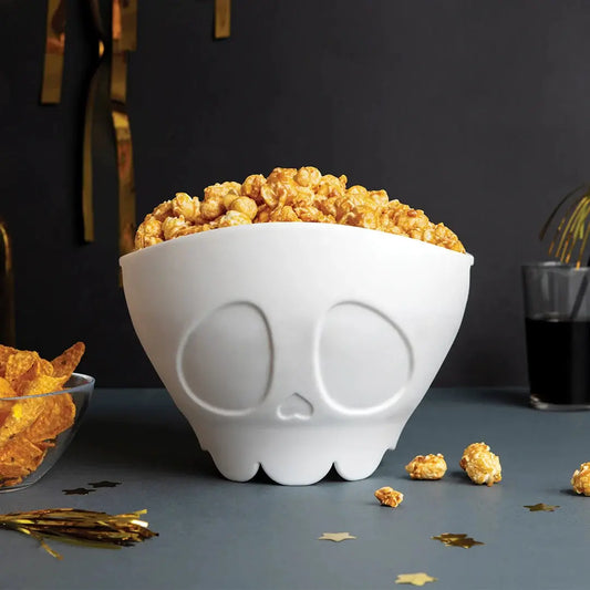 OTOTO DESIGN Scary Poppings skull-shaped popcorn bowl brimming with caramel popcorn on Tampa Home & Garden Store