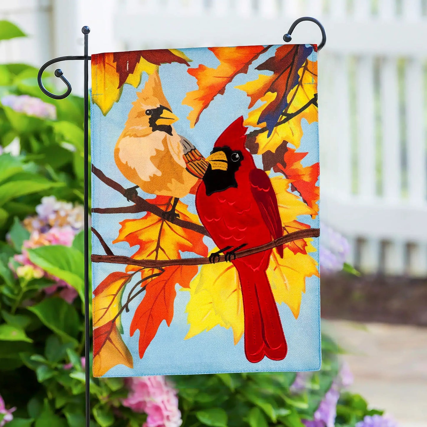Black metal scroll garden flag stand holding a vibrant autumn leaf flag on Tampa Home & Garden Store