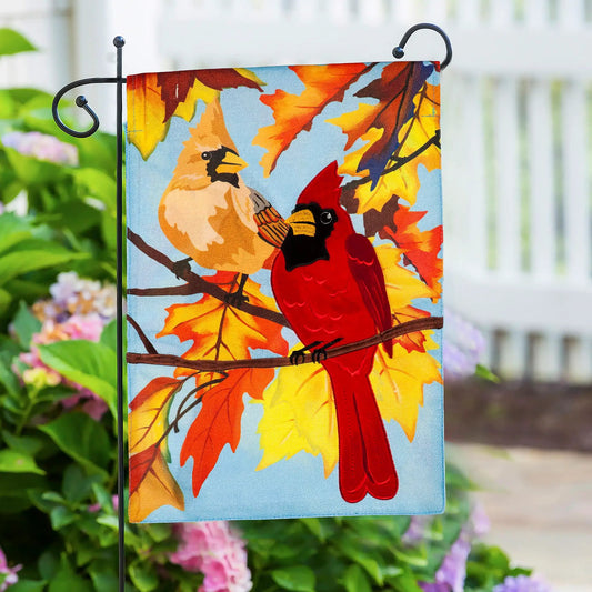 Black metal scroll garden flag stand holding a vibrant autumn leaf flag on Tampa Home & Garden Store