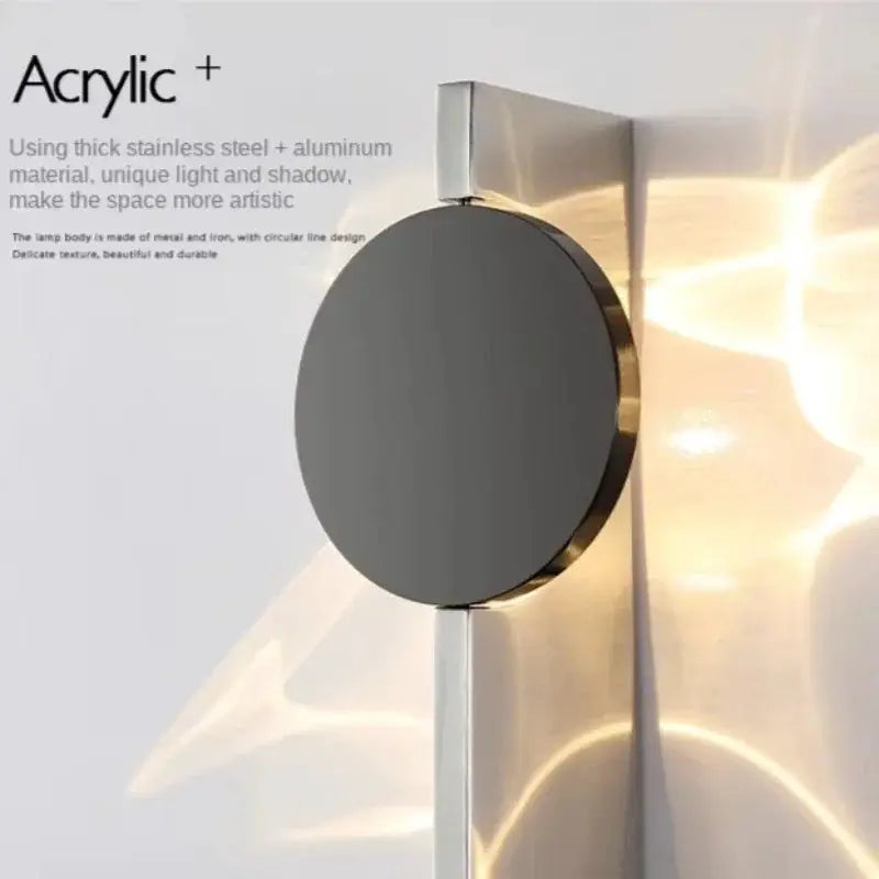 Stainless rotatable LED wall sconce with circular dark-gray disc and chrome mounting on wall on Tampa Home & Garden Store