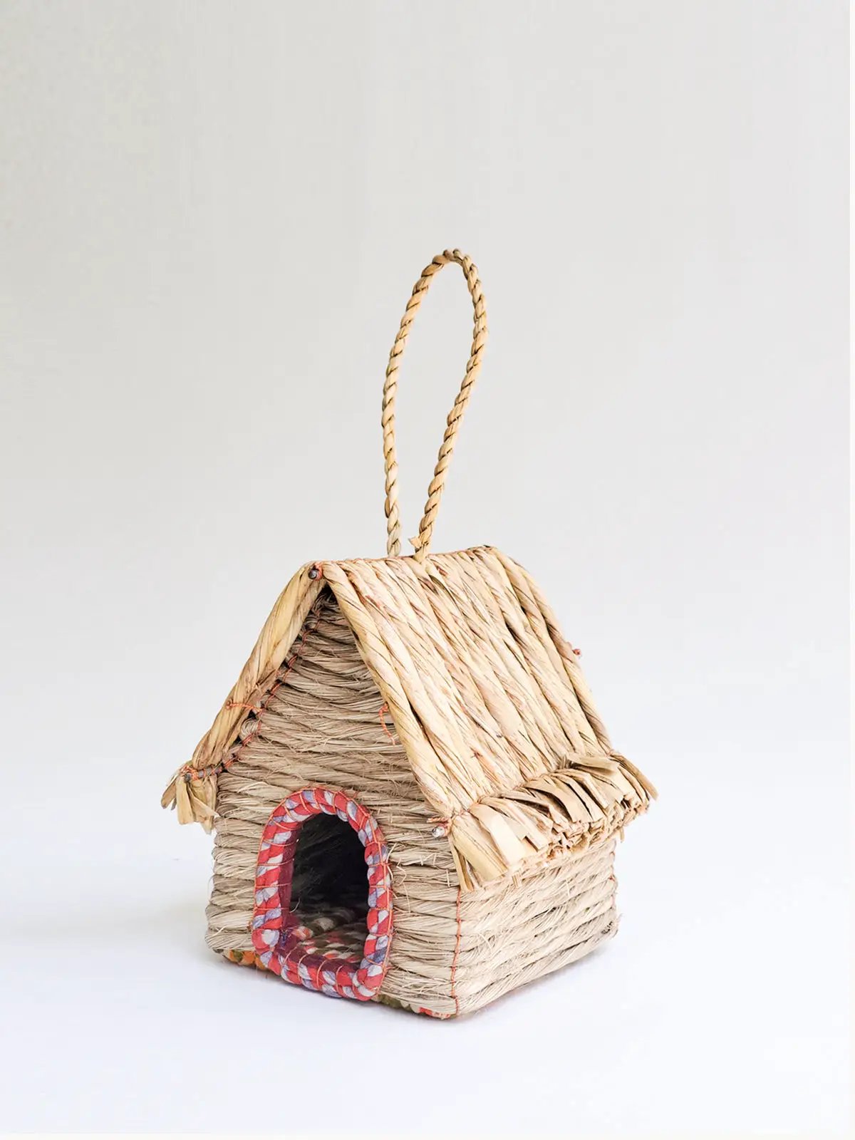 Seagrass and sari handcrafted birdhouse with woven natural fibers and red-trim circular entrance by KORISSA on Tampa Home & Garden Store