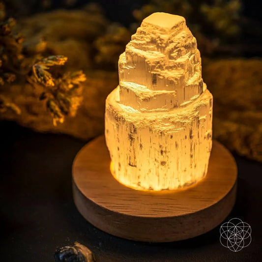 Selenite cleansing lamp Conscious Items on wooden base emits warm amber glow on Tampa Home & Garden Store