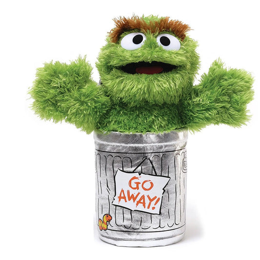 Sesame Street Oscar the Grouch plush with bright green fur perched on a newspaper-print trash can on Tampa Home & Garden Store
