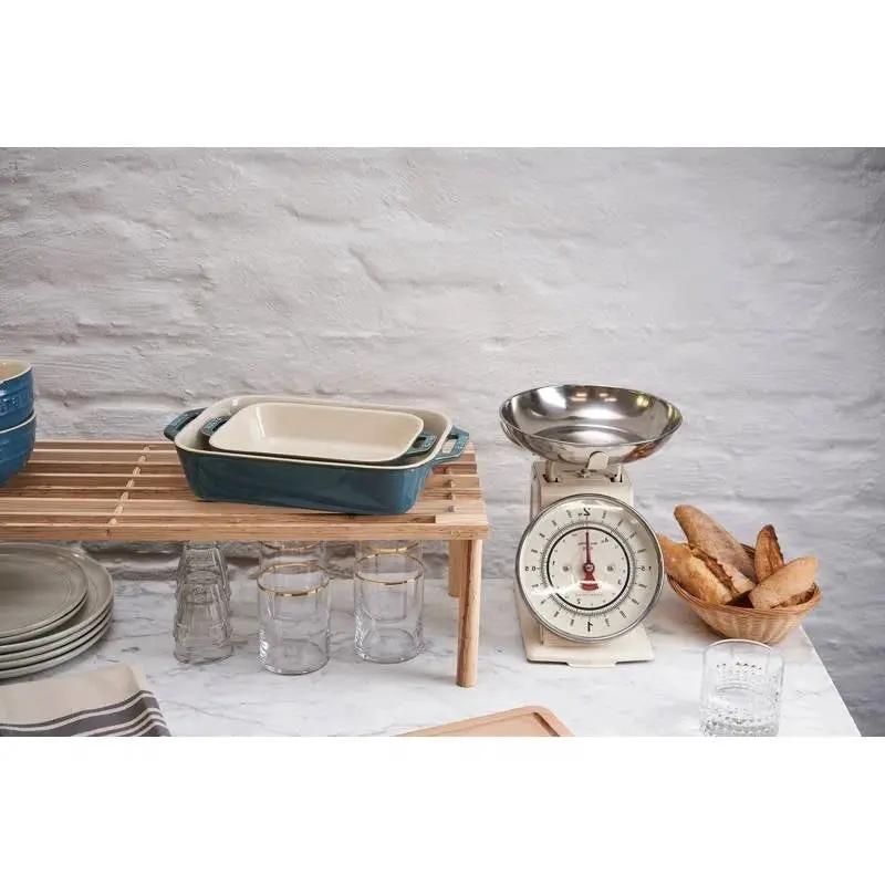 Stoneware baking dishes set of 2 in turquoise ivory ceramic bakeware stacked on a wooden rack on Tampa Home & Garden Store