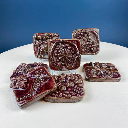 Set of 7 handmade 3D ceramic tiles with dark red glaze and raised beadwork wall decor on Tampa Home & Garden Store