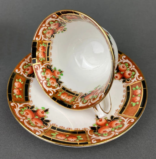 Two hand-painted porcelain tea cups and saucers with rose motif and gold trim on Tampa Home & Garden Store