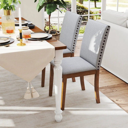 Set of 2 upholstered dining chairs in walnut with light gray fabric and nailhead trim on Tampa Home & Garden Store