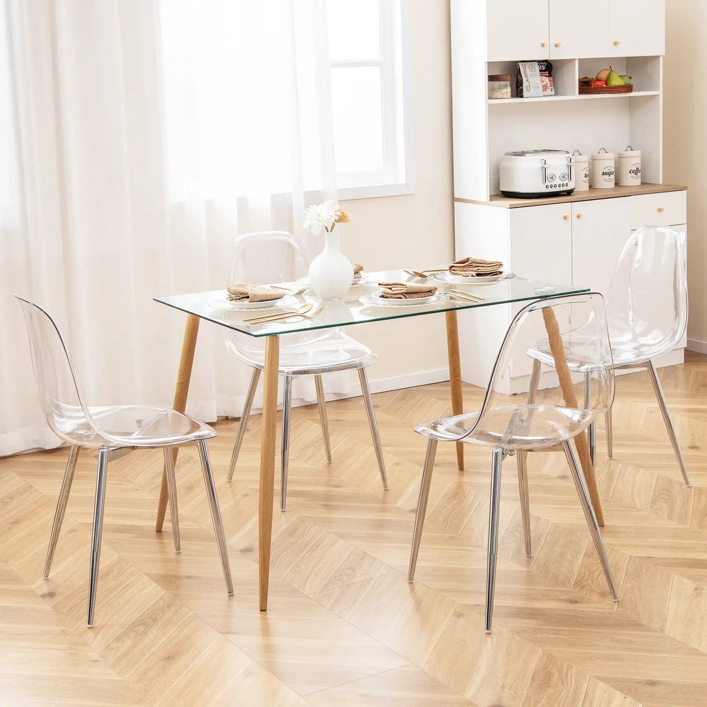 Set of four modern dining chairs with clear acrylic seats and metal legs on Tampa Home & Garden Store