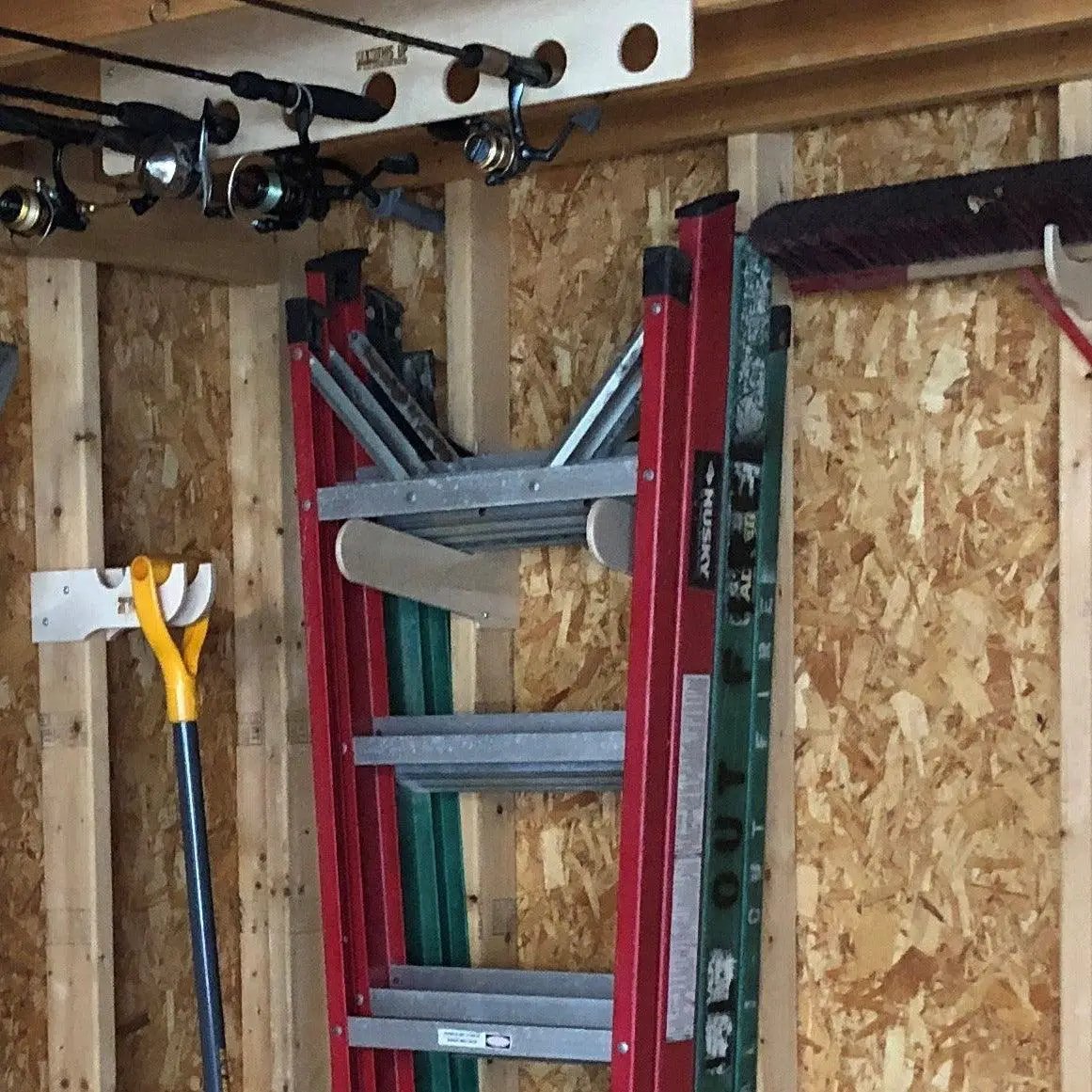 Shed tool organizer and step ladder storage rack with red metal frame and wall-mounted rungs on Tampa Home & Garden Store
