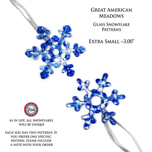 Handmade blue glass snowflake ornament with studioTica logo on silver chain on Tampa Home & Garden Store