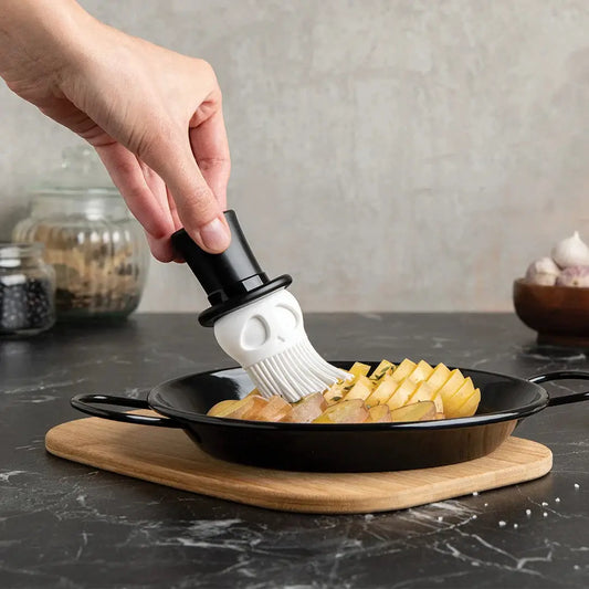 Skully Basting Brush by OTOTO DESIGN, skull-shaped silicone bristles with black handle on Tampa Home & Garden Store