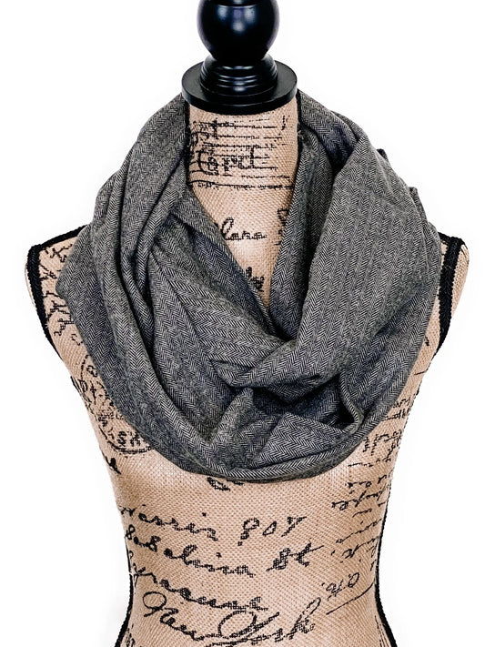 Flannel scarf smokey gray and black herringbone draped around mannequin neck on Tampa Home & Garden Store