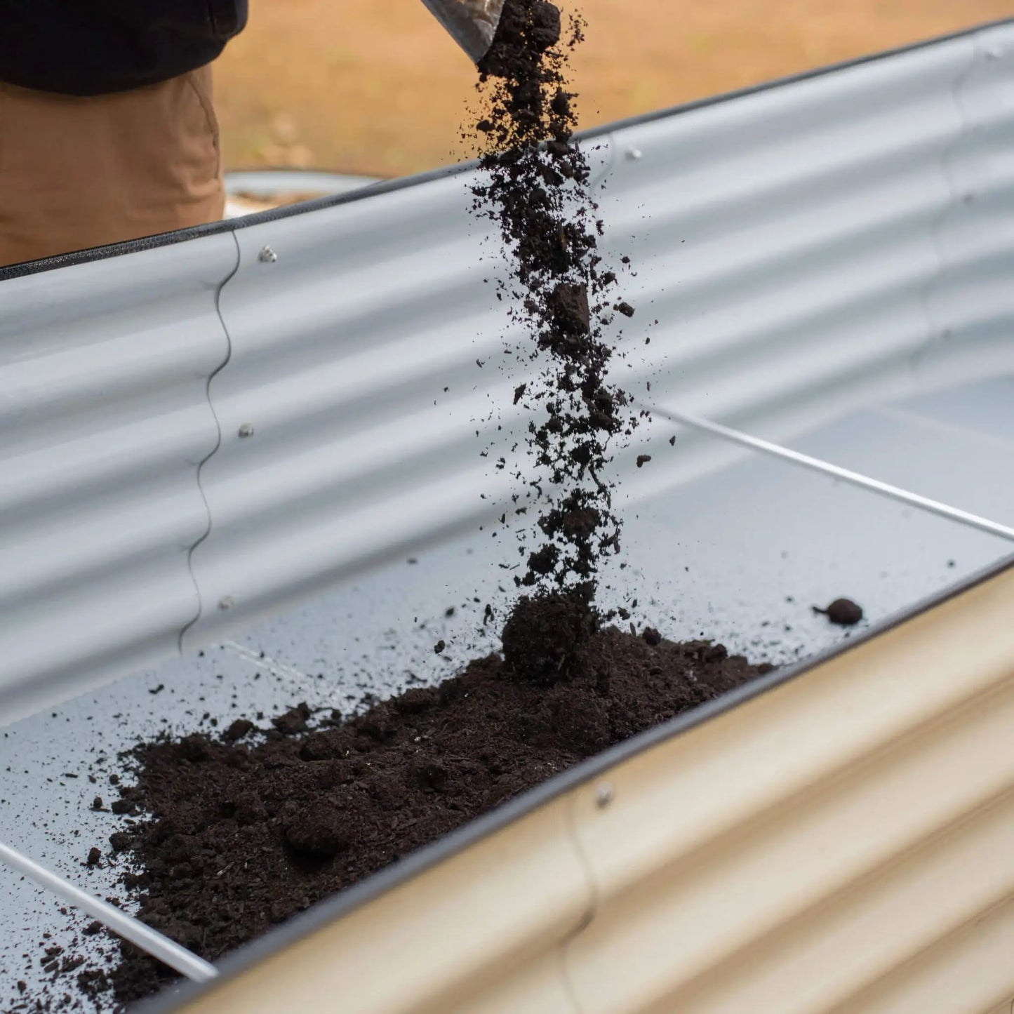 Vego Soil Saving Floor for 32 inch tall raised garden bed; galvanized metal bed with soil pouring in on Tampa Home & Garden Store