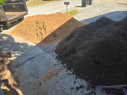 Soil and mulch delivery executed in one trip and dumped in separate piles.