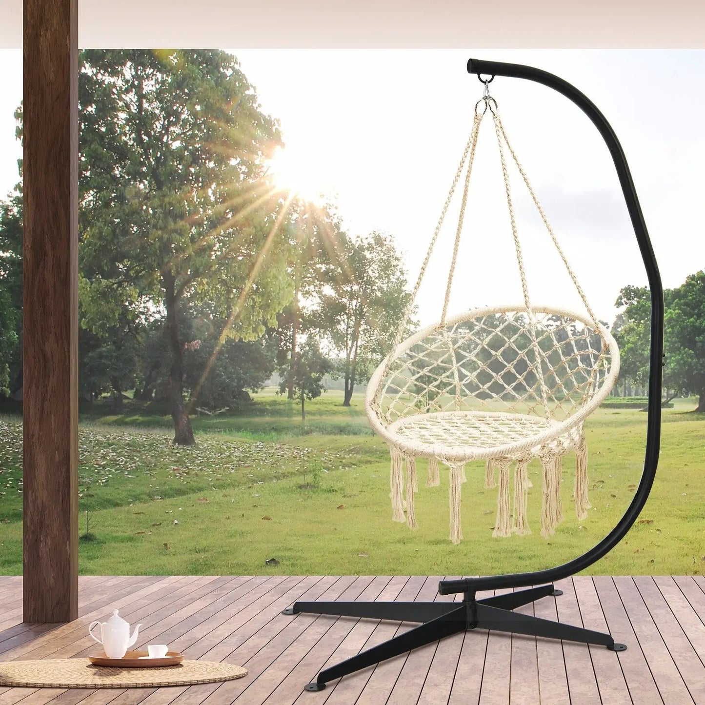 Solid steel C hammock frame stand with black arc supports a cream hammock chair on a deck on Tampa Home & Garden Store