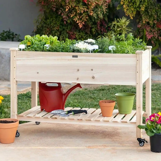 Solid wood raised planter on locking caster wheels with lower shelf filled with herbs on Tampa Home & Garden Store