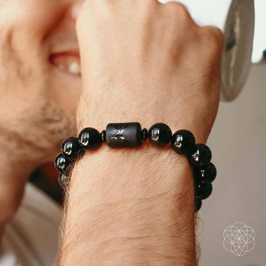 Soul Cleansing Black Obsidian Bracelet with glossy round beads and a carved center bead on Tampa Home & Garden Store