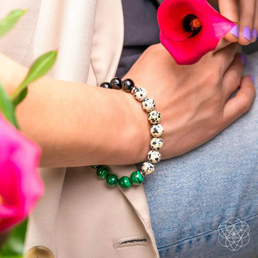 Dalmatian Jasper healing bracelet with cream speckled beads and green malachite bracelet on wrist on Tampa Home & Garden Store